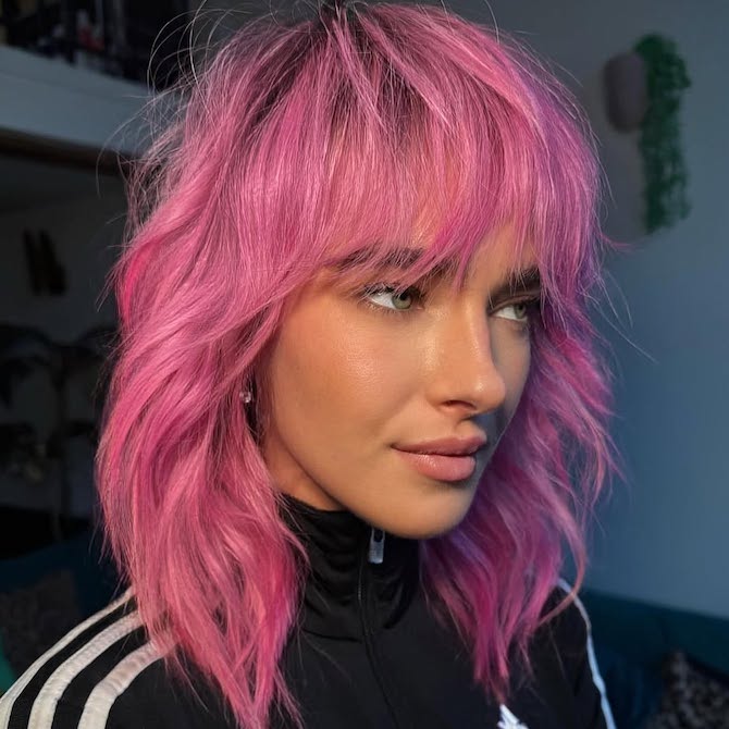 Model with shag haircut in a hot pink shade.