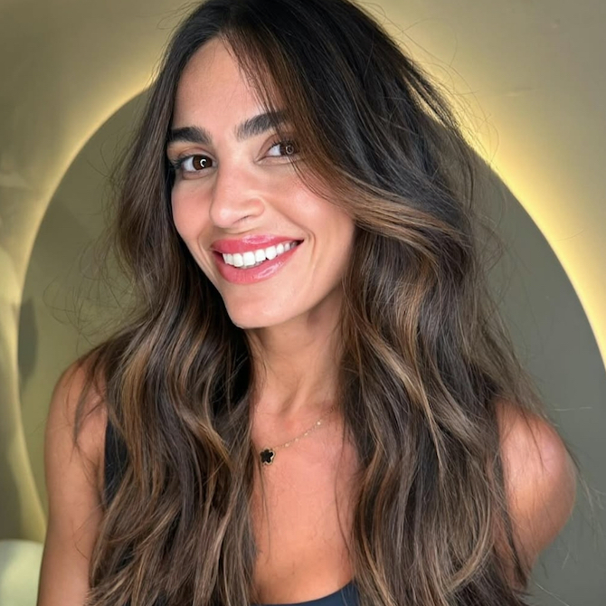 Subtle caramel highlights woven through dark brown hair for a soft, natural glow.