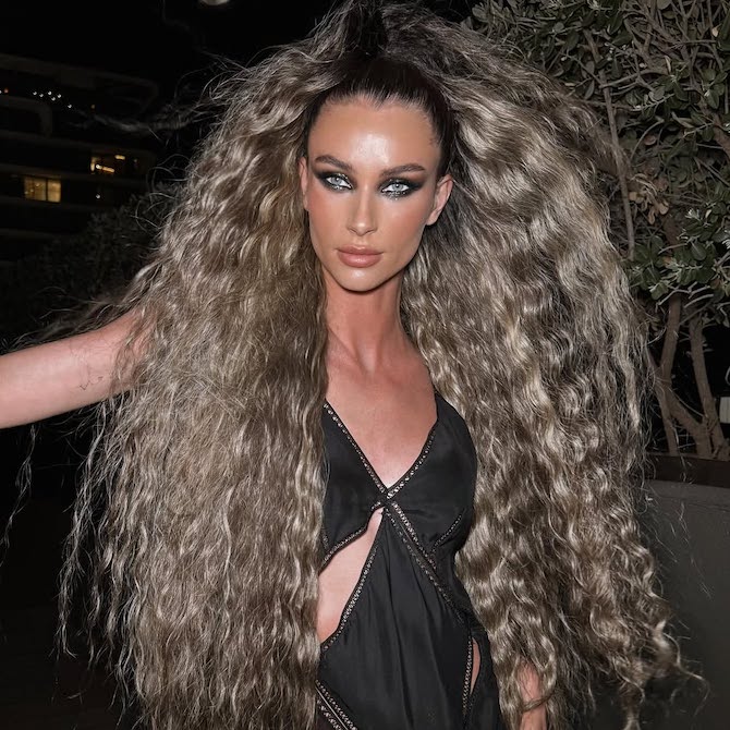 Model with ultra-long, bronde hair styled in crimped beach waves.