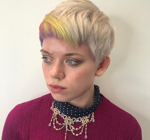 Woman with blonde pixie cut and rainbow hair