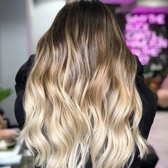 Back of a woman’s head with blonde ombre hair, created using Wella Professionals