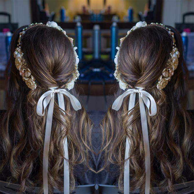 Mirrored image of woman with long chestnut brown hair with New Years Eve hair accessory