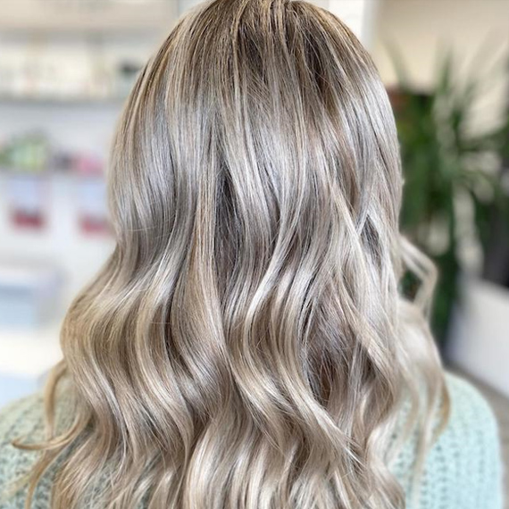 Back of woman’s head with ash blonde hair, created using Wella Professionals