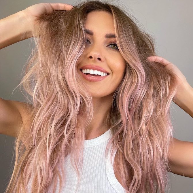 Model with beachy blonde, tousled hair and pastel pink balayage.