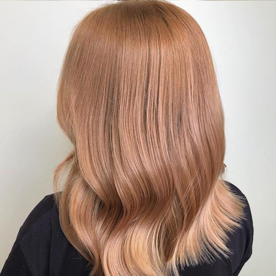 Photo of the back of a woman’s head with strawberry blonde hair, created using Wella Professionals