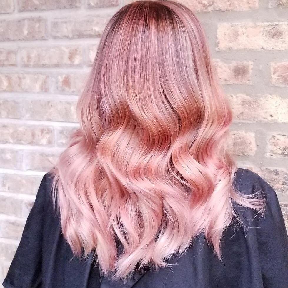 Woman with wavy pastel pink hair