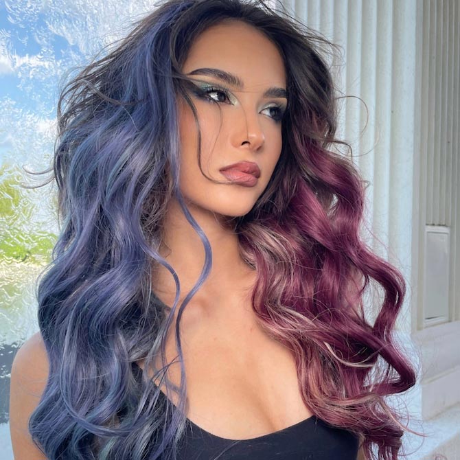 Model with long, dark hair featuring blue highlights on one side and purple highlights on the other.
