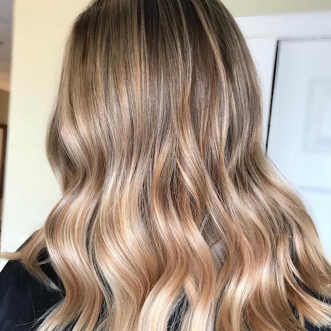Back of woman’s head with tweed blonde balayage, created using Wella Professionals.