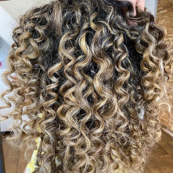 curly brown hair with blonde tips