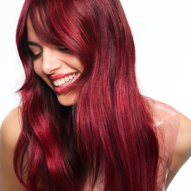 Model with long hair featuring a glossy, cherry red Color Touch Melt.