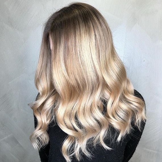 Woman with cream soda blonde hair, created using Wella Professionals.