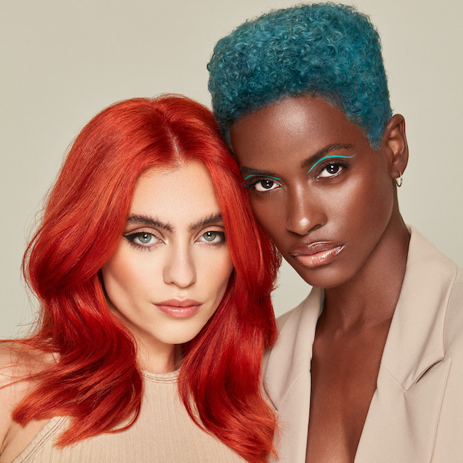 Two models - one with bright orange-red, straight hair and one with teal green, coily hair.