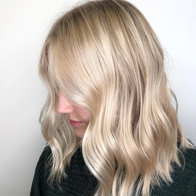 Side profile of model with wavy, blonde, mid-length hair, created using Wel...