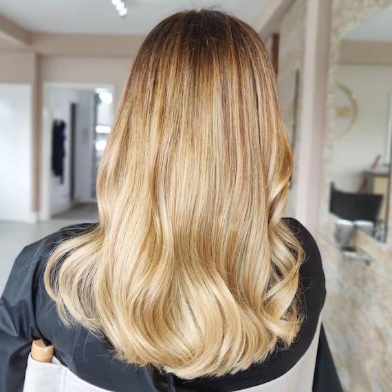 Photo of the back of a woman’s head with long honey blonde hair, created using Wella Professionals