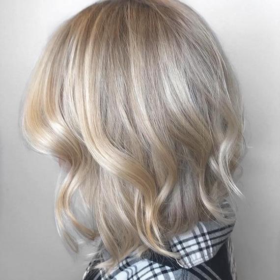 Side profile photo of woman with short vanilla blonde hair, created using Wella Professionals