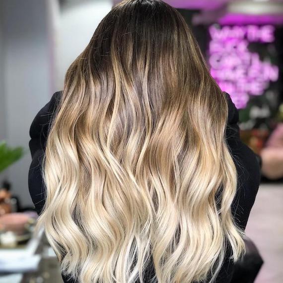 Back of a woman’s head with blonde ombre hair, created using Wella Professionals