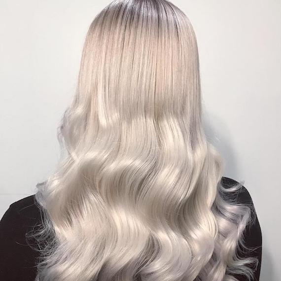 Photo of the back of a woman’s head with long ice blonde hair, created using Wella Professionals