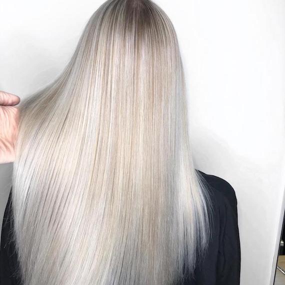 Photo of the back of a woman’s head with long, straight, silver blonde hair, created using Wella Professionals