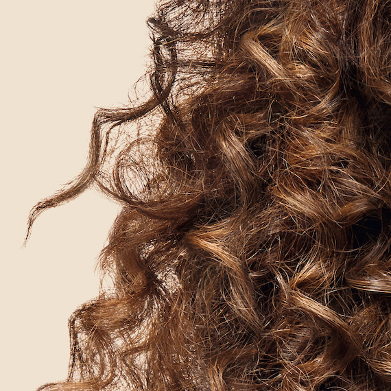 Close up of light brown type 3 brown curly hair 