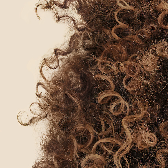 Close up of light brown type 4 brown curly hair 