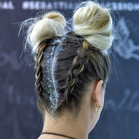 Side profile of model wearing braided ponytail and glitter roots, created using Wella Professionals