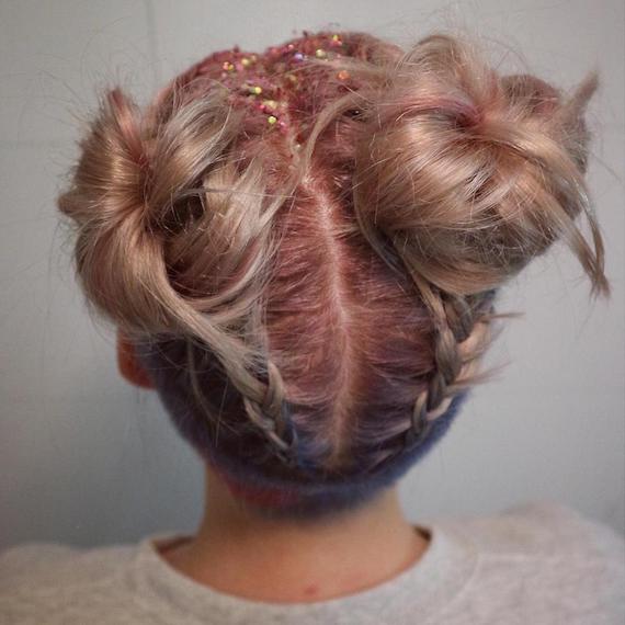 Close-up of model wearing braided space buns and glitter roots, created using Wella Professionals