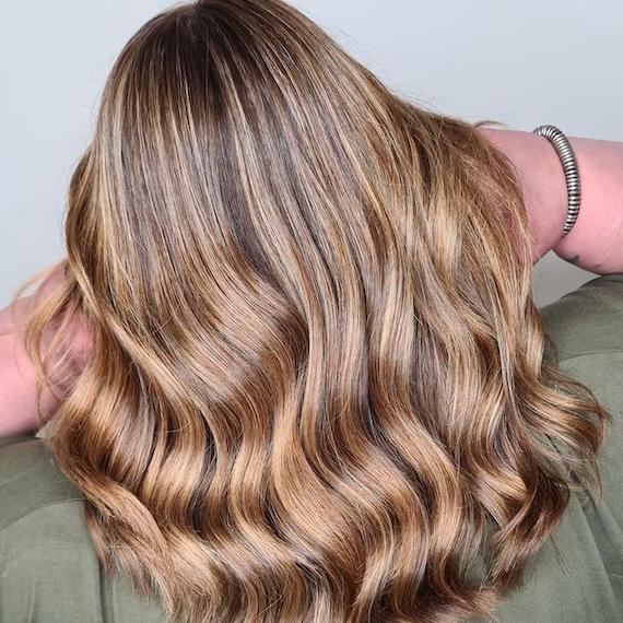 Back of woman’s head with mid-length bronde hair, created using Wella Professionals. 