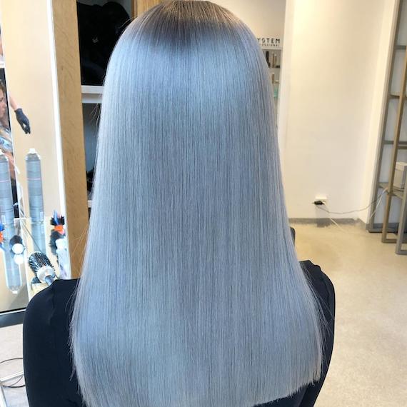 Back of woman’s head with super straight, gray blue hair, created using Wella Professionals.