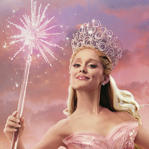 Ariana Grande appears as Glinda, holding a magic wand and wearing a silver crown.