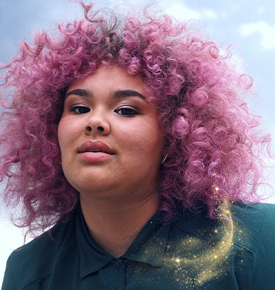 Model with full, curly, bright pink hair.