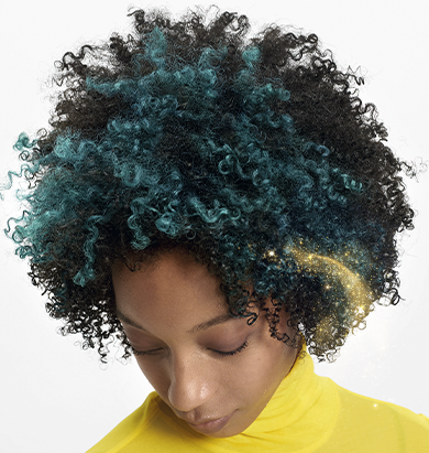 Model with dark, curly hair featuring an emerald green color block.