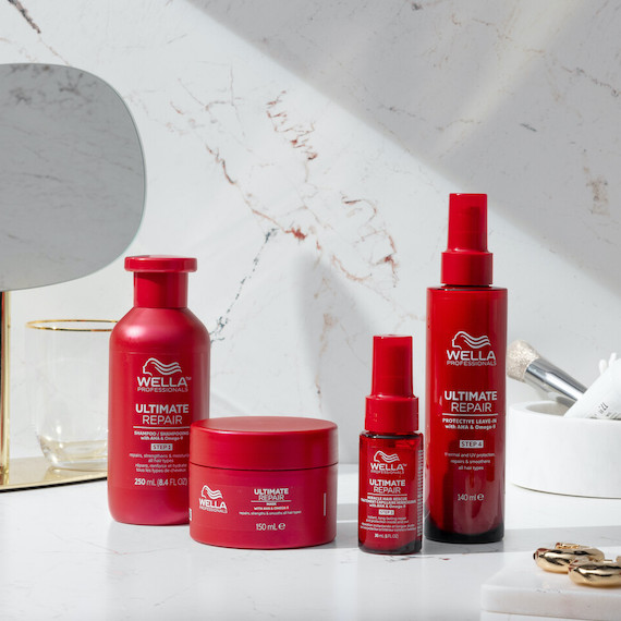 ULTIMATE REPAIR collection including Shampoo, Mask, Miracle Hair Rescue and Protective Leave-In on a marble surface.