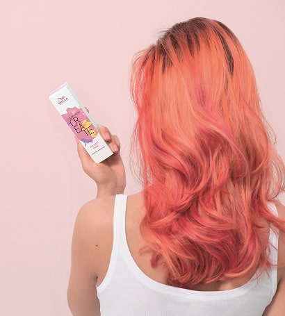 Image of woman with peach hair holding a Color Fresh Create box