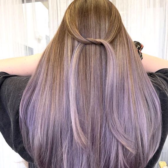 Back of model’s head with long, ash blonde ombre hair and lavender tones through the ends.