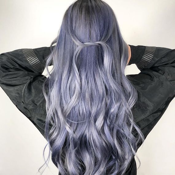 Back of model’s head with long, loosely curled, ash blue and dark gray hair.