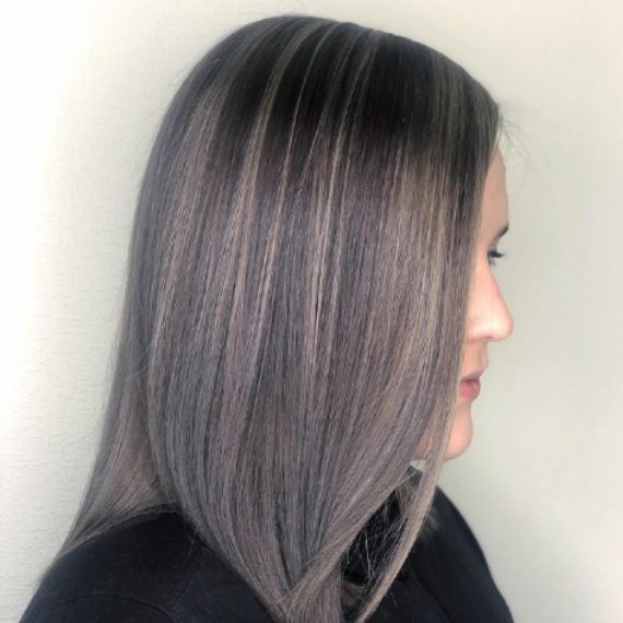 profile of woman with medium length hair in smoky ash gray hair color