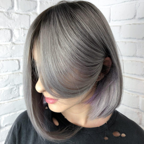 woman with long bob hair in warm ash gray color