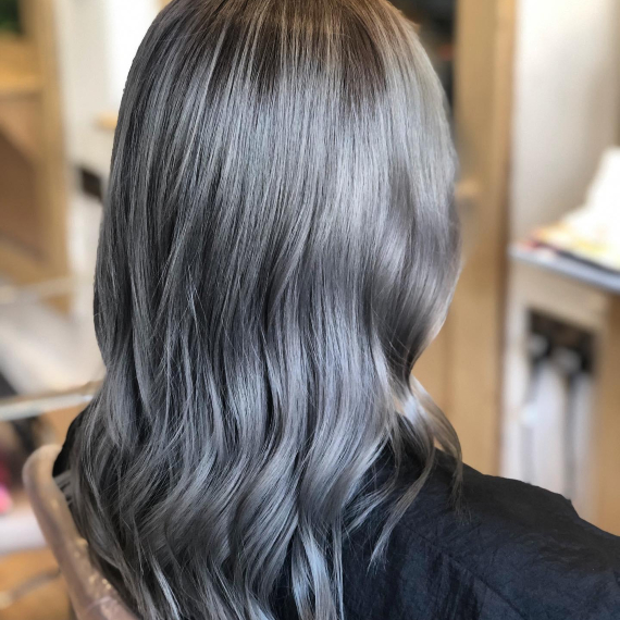 back of woman’s head with mid-length hair in metallic ash gray 