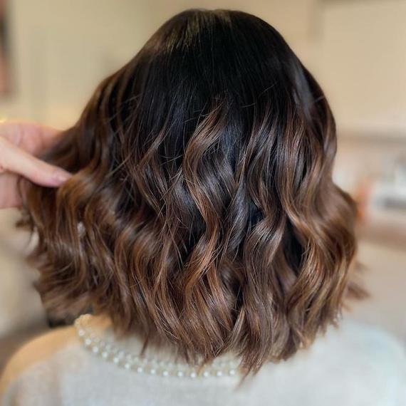 Back of woman's head with a brunette bob and balayage, created using Wella Professionals.