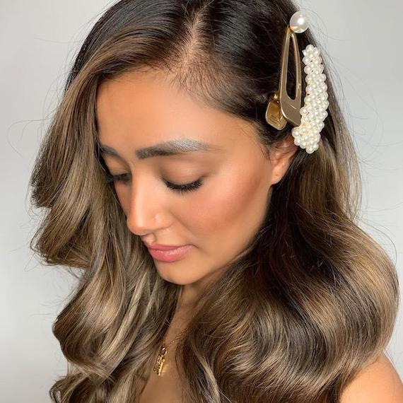 Photo of woman with brunette balayage and a hair accessory, created using Wella Professionals.