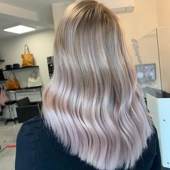 Back of woman’s head with lilac frost balayage through straight hair, created using Wella Professionals. 