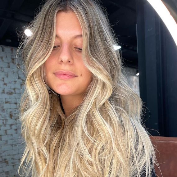 Woman facing camera with long, wavy, beachy hair, created using Wella Professionals.