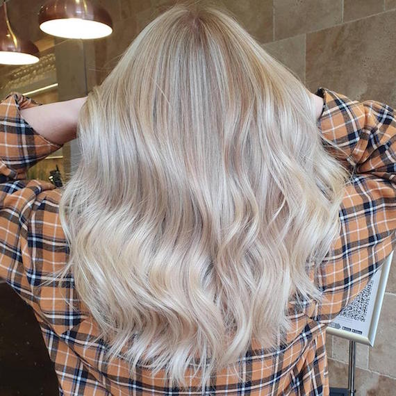 Back of woman’s head with beige blonde highlights, created using Wella Professionals.