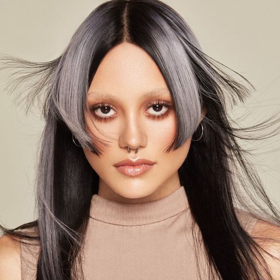 Model with long, straight, black hair and silver blonde highlights.