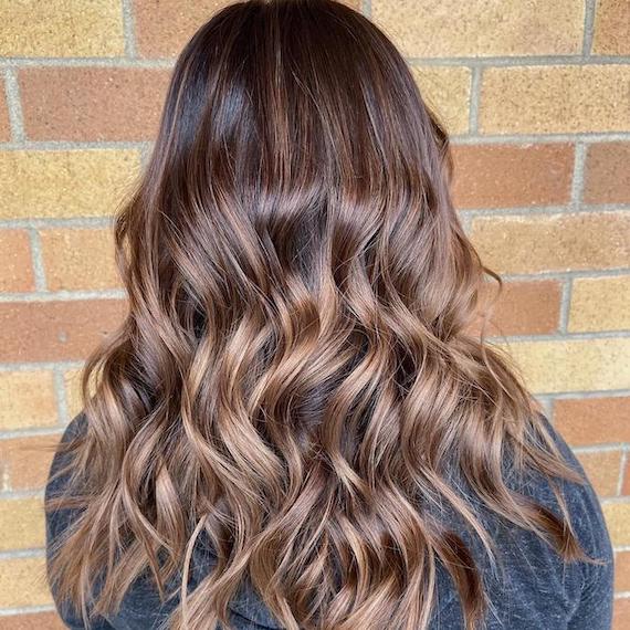 Back of woman’s head with cool brown to blonde balayage, created using Wella Professionals.