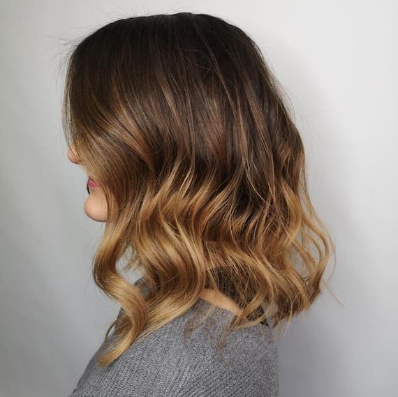 Side profile of woman with mid-length, bronde balayage hair, created using Wella Professionals.