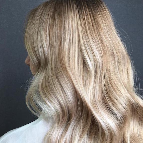 Babylights on long, wavy hair, created using Wella Professionals.