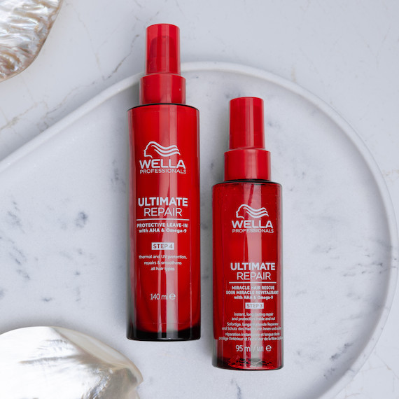ULTIMATE REPAIR Miracle Hair Rescue and Protective Leave-In on a marble surface.