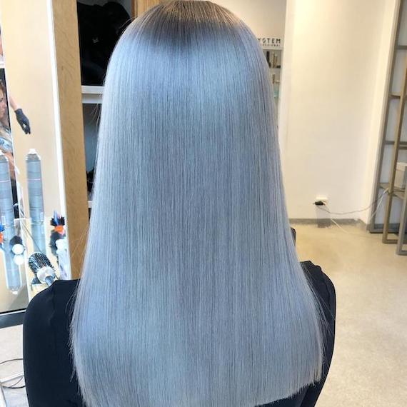 Back of woman’s head with long, super-straight, blue gray hair, created using Wella Professionals.