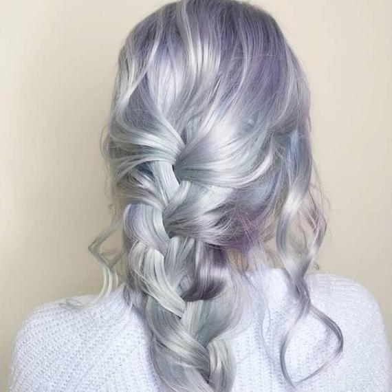 Back of woman’s head with long, waivy, blue grey hair in a braid, created using Wella Professionals.
